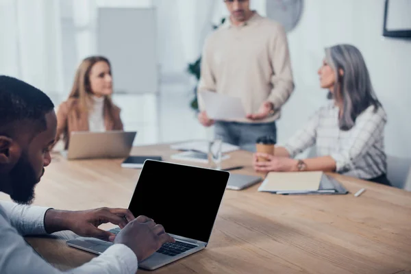 Selective Focus African American Man Using Laptop His Colleagues Talking — Stock Photo, Image