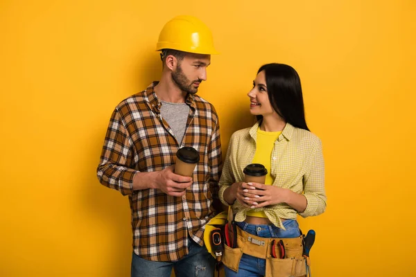 Uśmiechnięci Pracownicy Fizyczni Kawą Patrzą Siebie Żółto — Zdjęcie stockowe