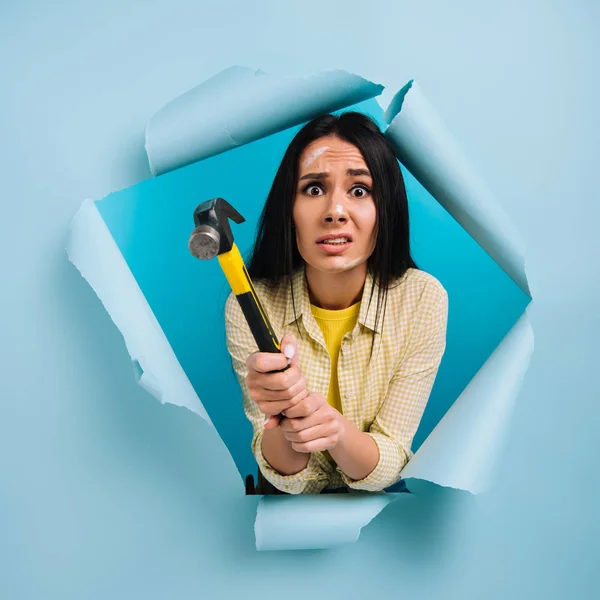 Worried Workwoman Dirty Face Paint Holding Hammer Torn Paper Isolated — Stock Photo, Image