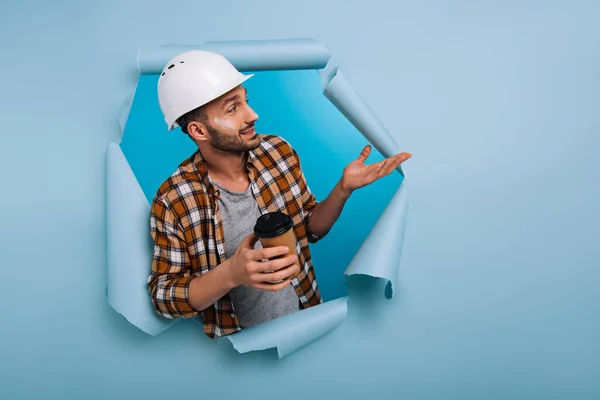 Foreman Hardhat Holding Coffee Torn Paper Isolated Blue — Stock Photo, Image