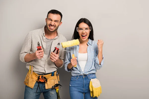 Successful Manual Workers Holding Pliers Paint Roller Grey — Stock Photo, Image