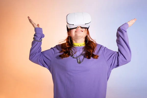 Happy Female Teenager Gesturing Using Headset Purple Beige — Stock Photo, Image