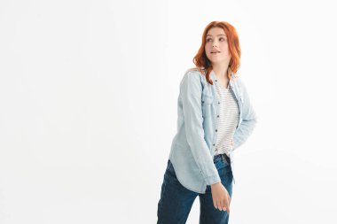cheerful redhead teen girl in denim clothes, isolated on white