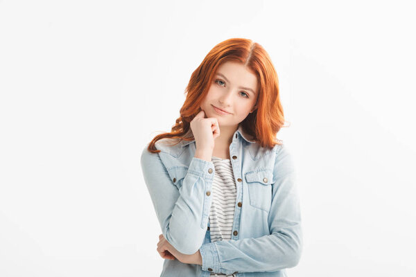 smiling redhead teen girl thinking in denim clothes, isolated on white