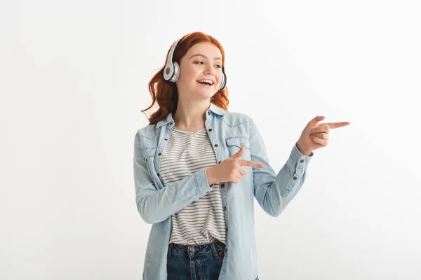 Excited Teen Girl Listening Music Headphones Pointing Isolated White — Stock Photo, Image