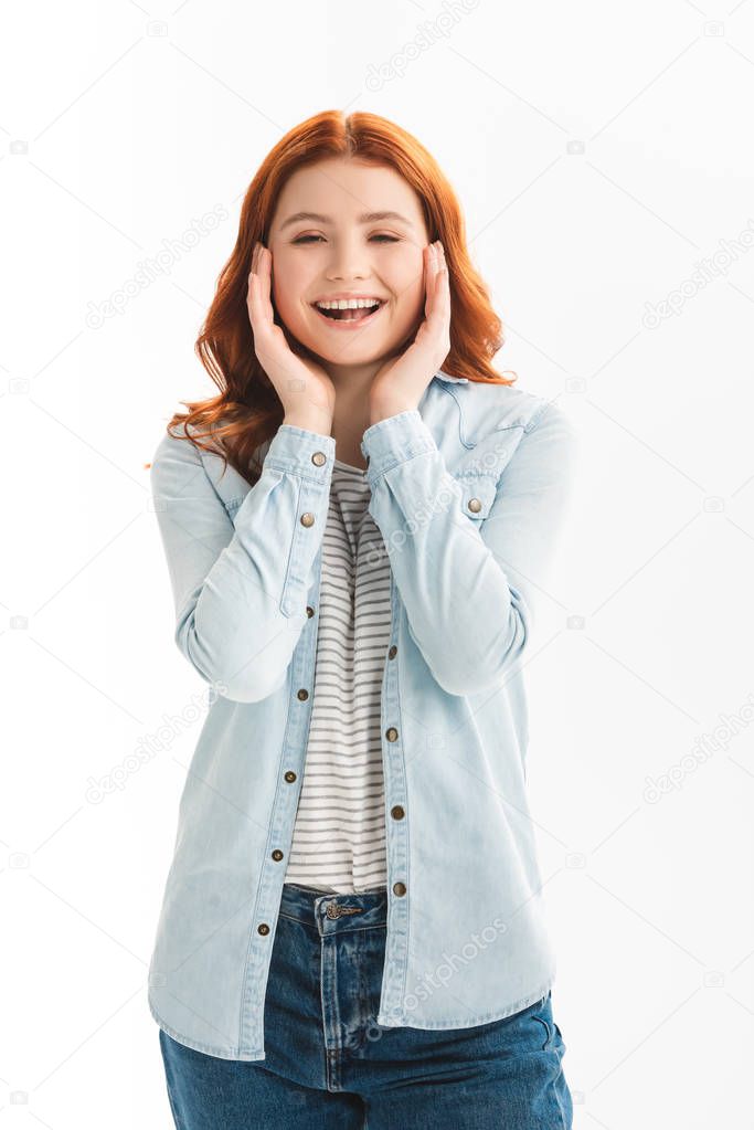excited redhead teen girl in denim clothes, isolated on white