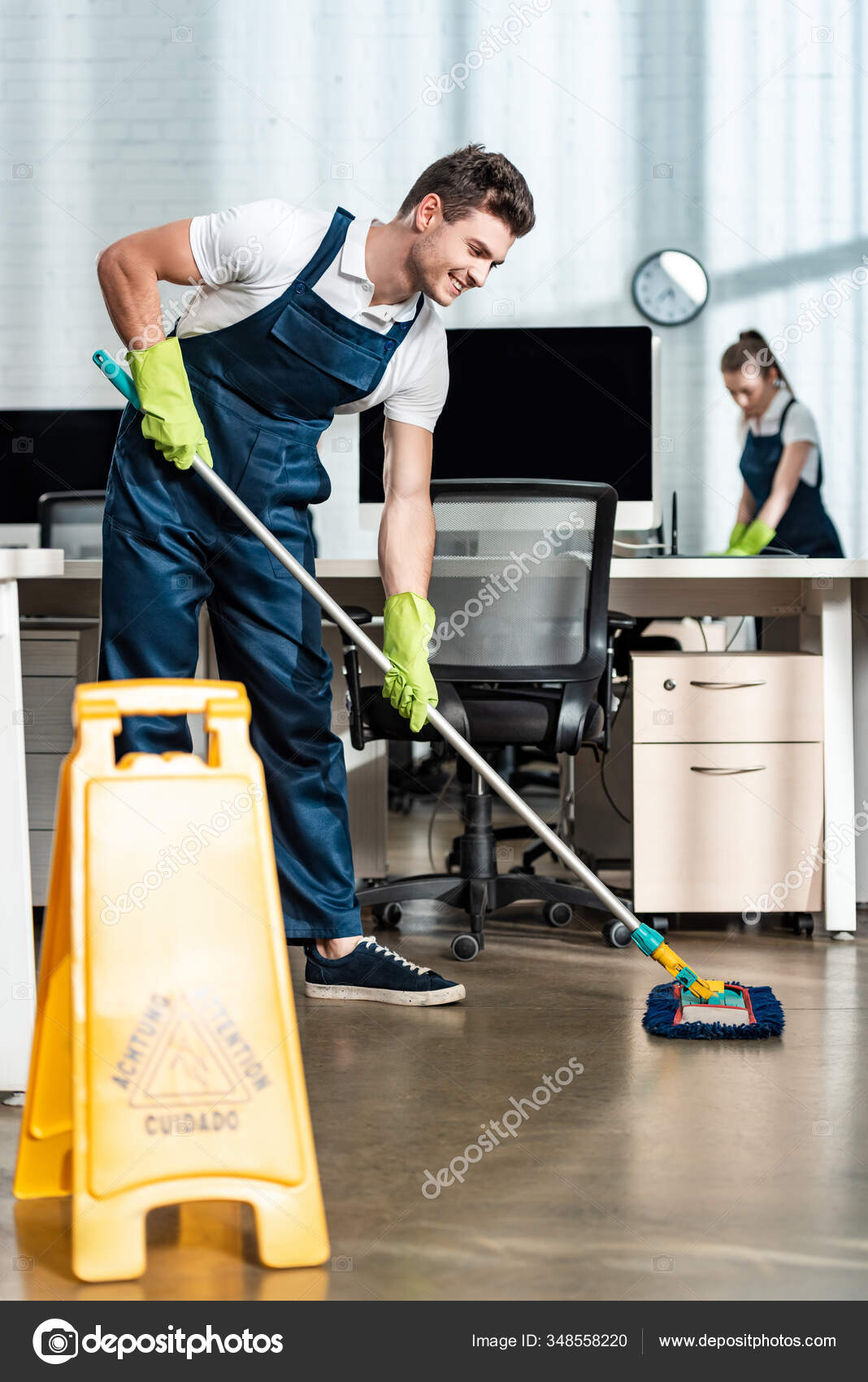 Smiling Cleaner Washing Floor Mop Colleague Cleaning Desk Stock Photo
