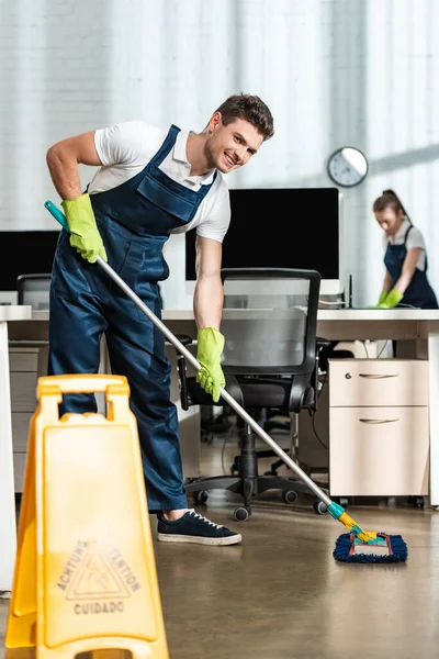 Cheerful Cleaner Washing Floor Mop While Smiling Camera — Stock Photo, Image