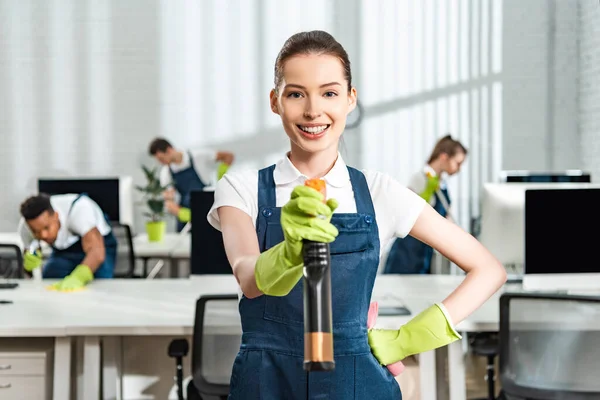 Cheerful Cleaner Overalls Standing Hand Hip While Holding Spray Bottle — Stock Photo, Image