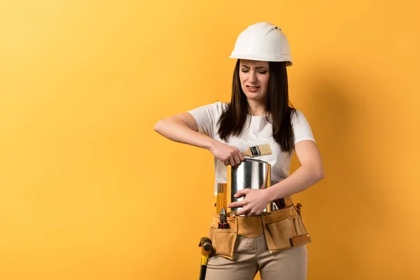 Disappointed Handywoman Opening Paint Can Yellow Background — Stock Photo, Image
