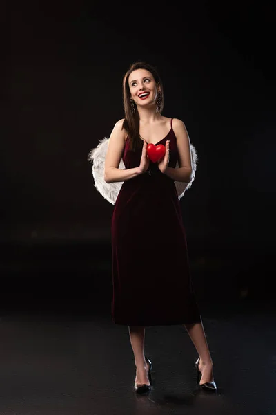 Smiling Woman Dress Wings Holding Heart Shaped Model February Black — Stock Photo, Image