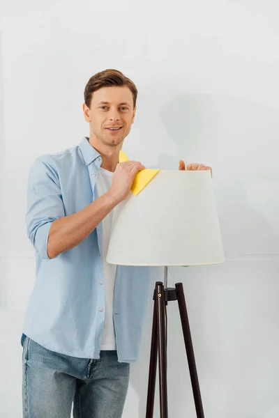 Man Smiling Camera While Cleaning Floor Lamp Rag White Background — Stock Photo, Image