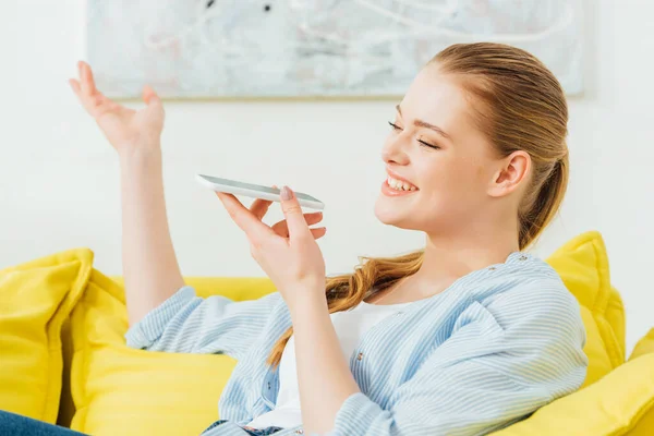 Sidovy Leende Kvinna Gester När Använder Högtalartelefon Smartphone Soffan — Stockfoto