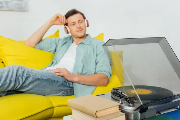 Selektiver Fokus Von Plattenspieler Und Büchern Auf Couchtisch Und Mann — Stockfoto