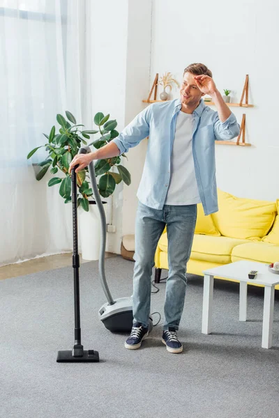 Homem Sorrindo Enquanto Usa Aspirador Sala Estar — Fotografia de Stock