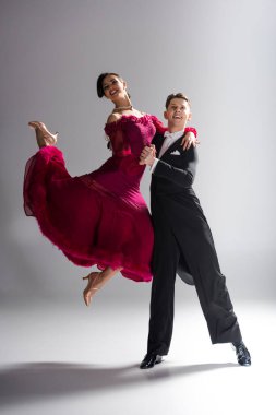 Kırmızı elbiseli, beyaz elbiseli, dans eden, zarif, genç dansçılar.