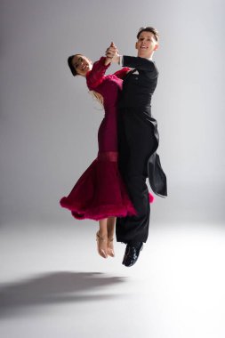 Kırmızı elbiseli, beyaz elbiseli, dans eden, zarif, genç dansçılar.