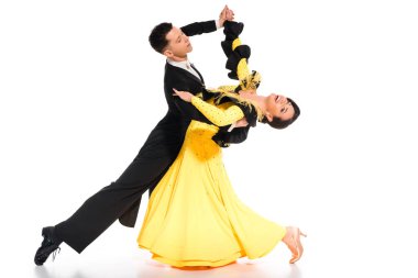 elegant young couple of ballroom dancers in yellow dress and black suit dancing on white clipart