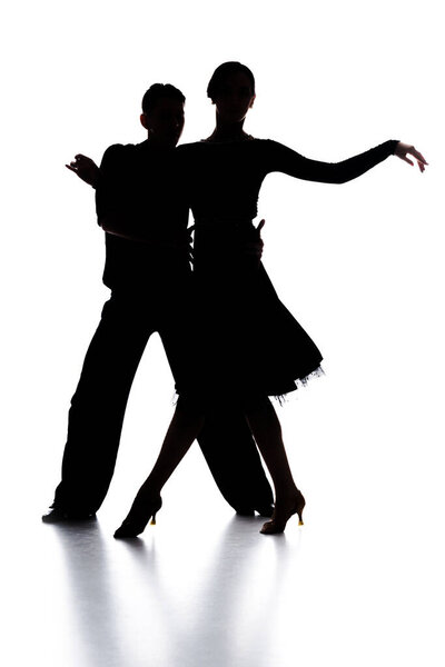 Силуэты элегантной пары танцоров, танцующих на белом
