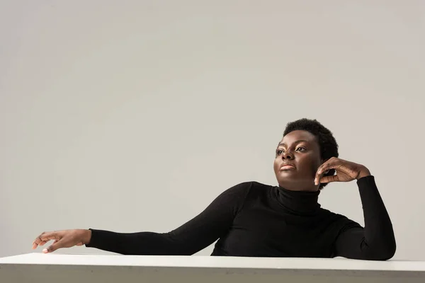 Confident African American Woman Black Turtleneck Sitting Table Isolated Grey — Stock Photo, Image