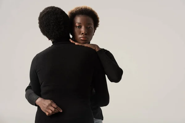 Attractive African American Girls Black Turtlenecks Hugging Isolated Grey — Stock Photo, Image