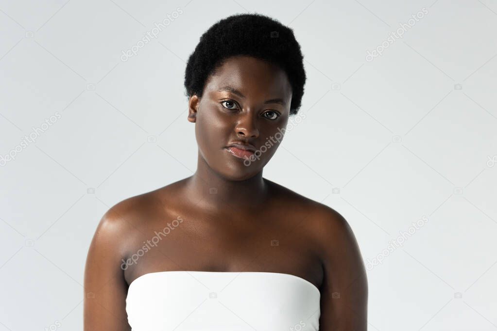 attractive african american girl in white top isolated on grey