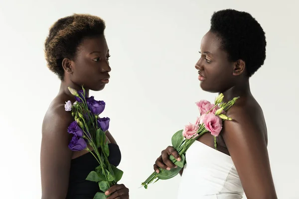 Chicas Afroamericanas Tops Sosteniendo Flores Rosadas Moradas Aisladas Gris — Foto de Stock