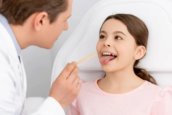 Selective Focus Ent Physician Holding Tongue Depressor Cute Kid Sticking — Stock Photo, Image