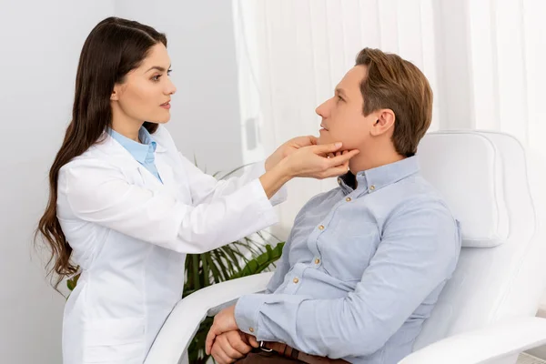 Beautiful Attentive Ent Physician Examining Handsome Patient Clinic — Stock Photo, Image