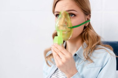 asthmatic woman using respiratory mask  clipart