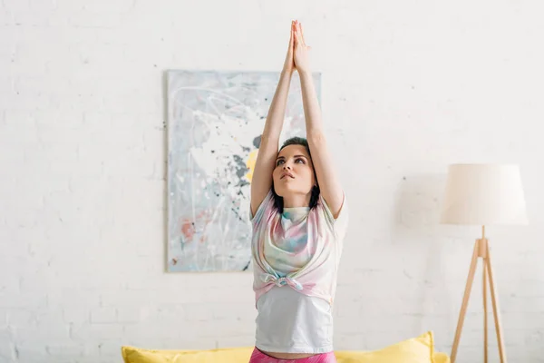 Renkli Saçlı Elleri Sıkılmış Bir Kadın Oturma Odasında Yoga Yapıyor — Stok fotoğraf