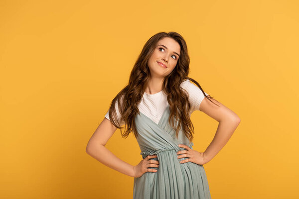 beautiful smiling spring woman with long hair isolated on yellow