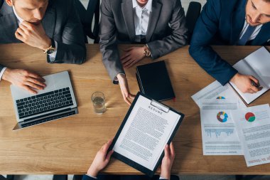 Overhead view of recruiters taking resume by employee during job interview   clipart