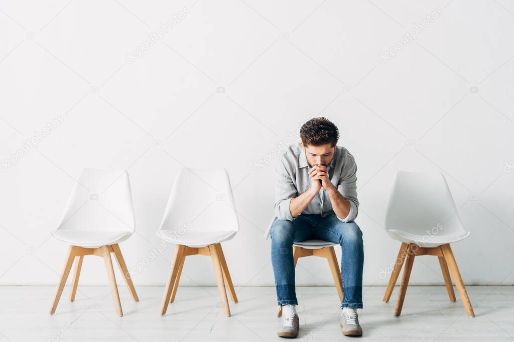 Pensive employee waiting for job interview in office 