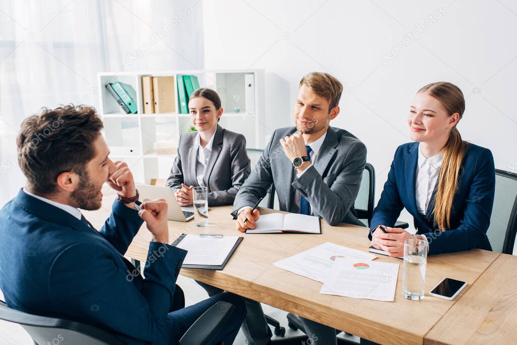 Employee showing yeah gesture during job interview with recruiters in office 