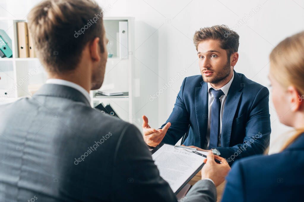 Selective focus of employee looking at recruiter during job interview 