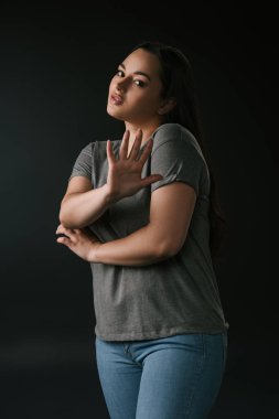 Confused plus size with stop gesture on black background clipart