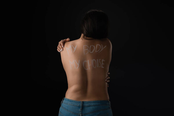 Back view of semi-dressed plus size model with lettering My Body My Choice on body isolated on black