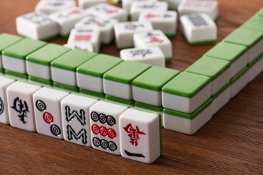 KYIV, UKRAINE - 30 Ocak 2019: Tahta yüzey üzerindeki mahjong oyununun seçici odak noktaları