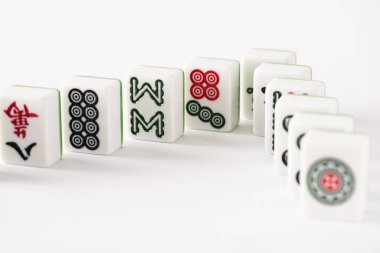 KYIV, UKRAINE - 30 HAZİRAN 2019: Beyaz arkaplanda işaretleri ve karakterleri olan mahjong oyununun seçici odak noktası