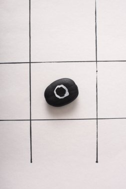 Tic tac toe oyununun üst görünümü üzerinde beyaz kağıt üzerinde hiçbir şey olmayan siyah kabarcık ile