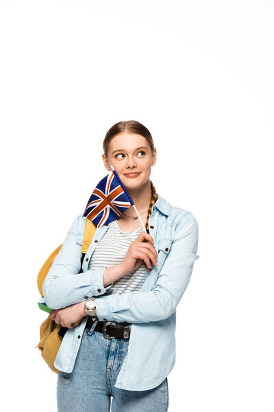 dreamy pretty student with backpack holding book and British flag isolated on white