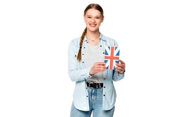 smiling pretty girl with braid holding book with uk flag isolated on white