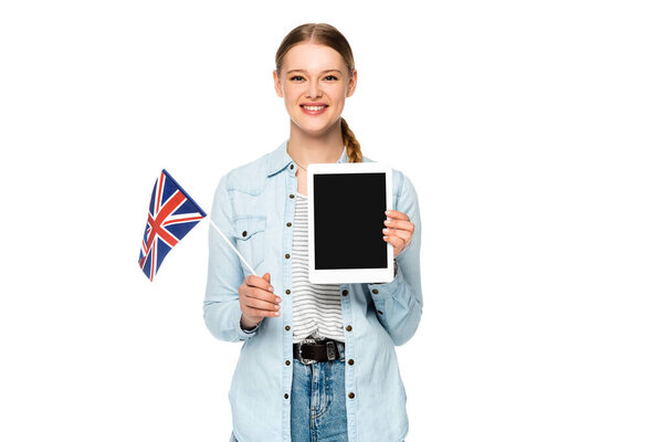 smiling pretty girl with braid holding digital tablet with blank screen and uk flag isolated on white