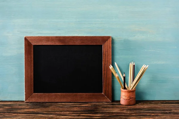 Empty Chalkboard Pencils Wooden Table Blue Wall — Stock Photo, Image