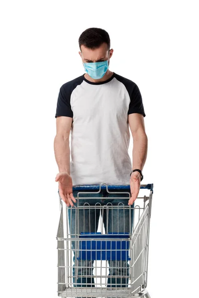 Man Medical Mask Gesturing While Looking Empty Shopping Cart Isolated — Stock Photo, Image