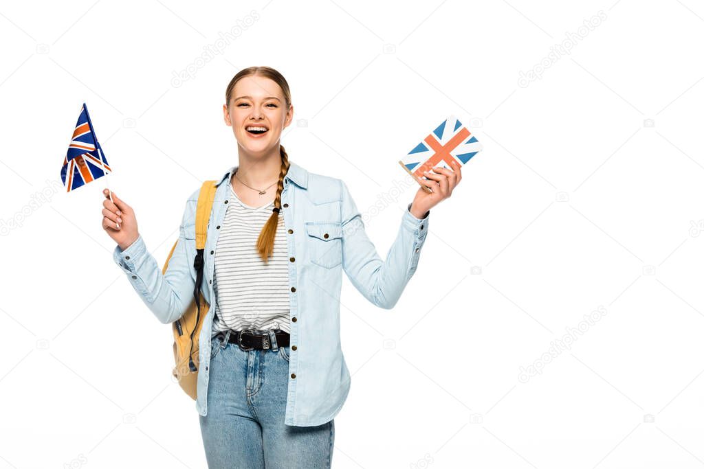 happy pretty student with backpack holding book and British flag isolated on white