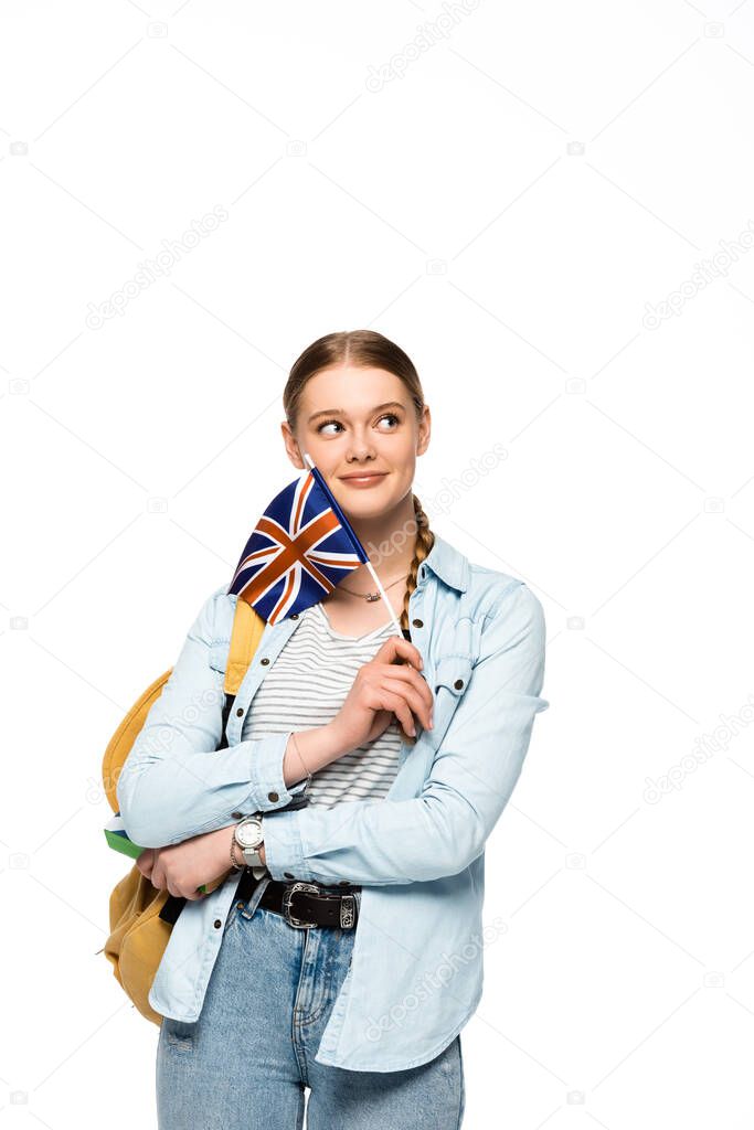dreamy pretty student with backpack holding book and British flag isolated on white