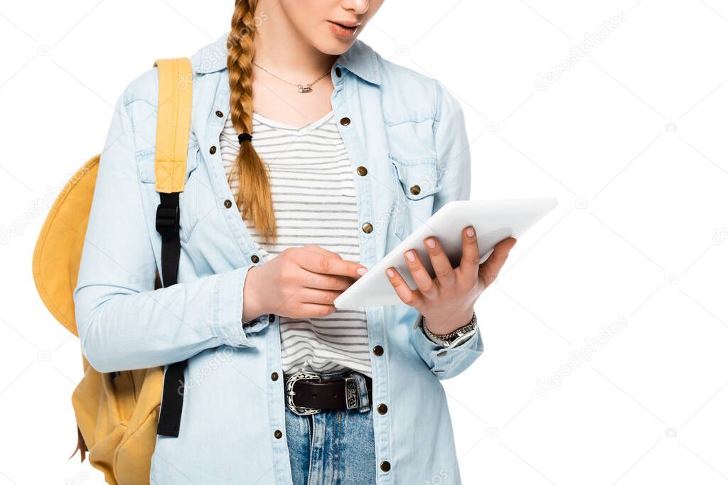 cropped view of student with backpack holding digital tablet isolated on white