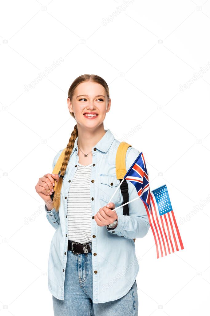 happy girl with braid and backpack holding flags of america and united kingdom isolated on white